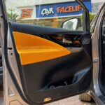 Innova Crysta done customized interior with black and mustard two tone color combination