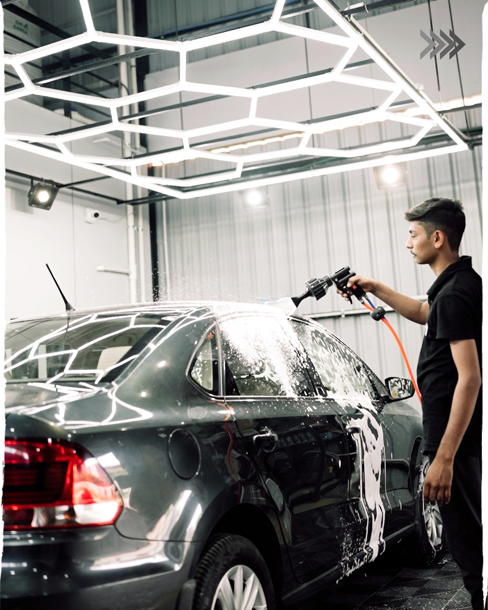 Detailing bay at Filmshoppee Rajkot studio with premium car polishing and restoration setup