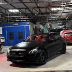 Detailed satin black car paint finish