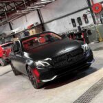 Satin black car paint finish on luxury sedan