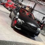 Side profile of satin black painted luxury car